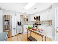 Modern kitchen with stainless steel appliances and granite countertops at 9149 Washam Potts Rd, Cornelius, NC 28031