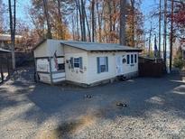 Quaint lakefront cottage with attached garage and RV parking at 101 Lake View Dr, Mount Gilead, NC 27306