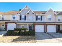 Two story townhome with attached garage and manicured landscaping at 11015 Alderbrook Ln, Charlotte, NC 28270