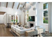 Bright living room features vaulted ceilings, a large sectional sofa, and a fireplace at 7483 Fighting Creek Rd # 37, Sherrills Ford, NC 28673
