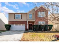 Two-story brick home with a two-car garage and landscaping at 11828 Bending Branch Rd # 42, Charlotte, NC 28227