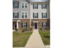 Two-story townhome with gray and brown siding, a walkway, and landscaping at 1725 Aspire St, Charlotte, NC 28262