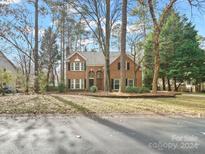 Charming two-story brick home with a landscaped front yard at 151 Paseo Dr, Mooresville, NC 28117