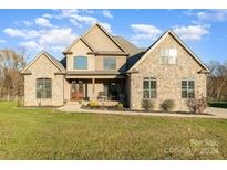 Two-story house with stone accents and a large front yard at 174 Bellingshire Dr, Mt Ulla, NC 28125