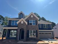 Two-story home with stone accents and a metal roof at 2011 Cedar Falls Dr # 71, Waxhaw, NC 28173