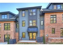 Gray and brick townhome exterior with a private patio at 2019 Thurmond Pl # 13, Charlotte, NC 28205