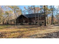Rustic log cabin home with stone accents, nestled in a wooded setting at 633 Weston Acres Rd, Fort Lawn, SC 29714