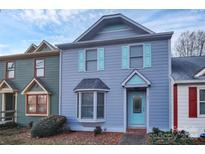 Two-story townhome with light blue siding, aqua shutters, and a teal front door at 805 Prince Albert Ct, Statesville, NC 28677