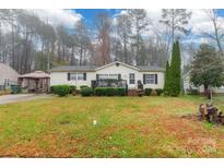 One-story home with a front porch, shrubs, and a driveway at 1232 Salvadore Ct, Gastonia, NC 28052