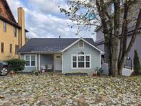 Charming light blue house with a covered porch and neatly landscaped yard at 316 Frazier Ave, Charlotte, NC 28216