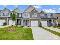 New townhome community with inviting front yards and two-car garages at 6346 Nandina Dr # 160, Harrisburg, NC 28075