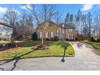 Brick two-story house with a large front yard and driveway at 10121 Enfield Ct, Fort Mill, SC 29707