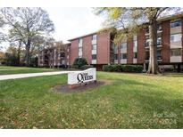 Brick building exterior with landscaping and signage for 1300 Queens at 1300 Queens Rd # 409, Charlotte, NC 28207