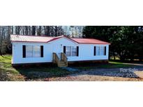 White single-wide mobile home with red roof and small yard at 3431 Polkville Rd, Shelby, NC 28150
