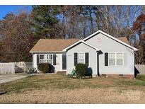 Gray house with a brown roof, small yard, and detached shed at 2405 Sloan Dr, Charlotte, NC 28208