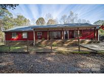 Red house with a large front porch and fenced yard at 1115 Marys Grove Church Rd # 1, Kings Mountain, NC 28086