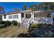Ranch style home with front porch and mature trees at 1020 Harper Keefe Rd, Indian Land, SC 29707