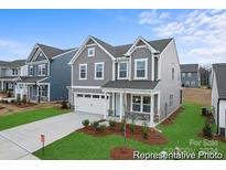 Two-story home with gray siding, stone accents, and a landscaped lawn at 121 Stonewater Dr # 21, Red Cross, NC 28129