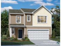 Two-story house with beige and brown siding, a two-car garage, and landscaping at 15229 Windy Plains Rd, Charlotte, NC 28262