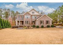 Brick two-story house with landscaping and large yard at 153 Leaning Tower Dr, Mooresville, NC 28117