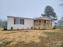 Newly renovated mobile home with covered porch and landscaped yard at 472 Buffalo Shoals Rd, Lincolnton, NC 28092