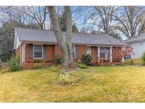 Brick ranch house with mature trees and a well-maintained lawn at 6426 Montpelier Rd, Charlotte, NC 28210