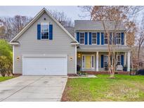 Charming two-story home with a two-car garage, front porch, and landscaped yard at 1345 Shimmer Light Cir, Rock Hill, SC 29732