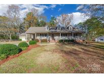 Ranch style home with front porch, attached garage, and landscaped yard at 2676 Pineview Dr, Lancaster, SC 29720