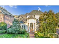 Two-story house with gray roof, white exterior, and brick walkway at 5300 Haynes Hall Pl, Charlotte, NC 28270