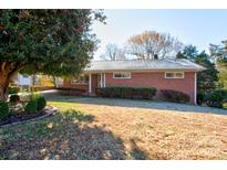 Brick ranch home with carport and mature landscaping at 236 Sidesmur Ne Ct, Concord, NC 28025