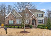 Two-story house with stone and siding accents, landscaping, and a welcoming front porch at 962 Castlewatch Dr, Fort Mill, SC 29708