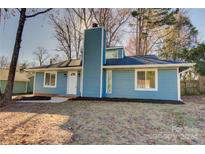 Newly renovated blue house with a landscaped yard and walkway at 2515 Dion Ave, Charlotte, NC 28212