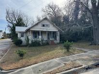 Fixer-upper home with front porch and mature trees at 307 E Arch St, Lancaster, SC 29720