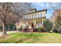 Charming two-story home with a welcoming front porch and landscaped yard at 8002 Morehouse Dr, Waxhaw, NC 28173