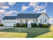 White one-story house with gray roof, attached garage, and manicured lawn at 1628 Beverly Ln, Lincolnton, NC 28092