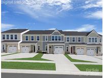 New townhome community with multiple units and attached garages at 1653 Respect Nw St, Concord, NC 28027