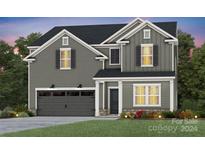 Two-story house with gray siding, two-car garage, and landscaping at 13725 Roderick Dr # 189, Huntersville, NC 28078