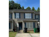 Two-story home exterior with blue shutters and a small front yard at 5343 Esther Ln, Charlotte, NC 28214