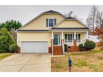 Attractive yellow house with brick accents and a covered porch at 828 Holdcroft Ln, Rock Hill, SC 29730