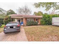 Front exterior of a one-story brick ranch home with a covered carport and attached storage at 1112 Fallston Rd, Shelby, NC 28150