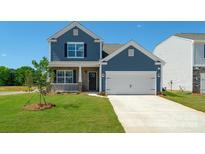 Two-story house with blue siding, brick accents, and a two-car garage at 185 Giant Oak Ave, Statesville, NC 28677