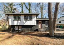 Charming two-story home with a pink door, black and white exterior, and landscaped yard at 3619 Bankston Pl, Charlotte, NC 28215