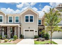 Attractive two-story townhome with a one-car garage and landscaped yard at 14906 Tamarack Dr, Charlotte, NC 28278