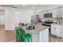 Modern kitchen featuring stainless steel appliances, granite countertops, and an island with bar seating at 524 Trading Post Ln, York, SC 29745