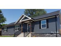 Gray house with black shutters, stone accents, and a covered porch at 6215 Faith Rd, Salisbury, NC 28146