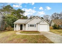 Simple one-story house with a garage and well-maintained lawn at 2321 Linda Lou Ct, Charlotte, NC 28213