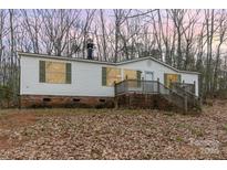 Single-wide mobile home with brick skirting and steps leading to a deck at 326 Chestnut Ridge Rd, Kings Mountain, NC 28086