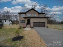 Brick two-story house with a two-car garage at 1304 Pleasant Plains Rd, Matthews, NC 28105