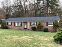 Charming brick ranch home with a well-manicured lawn and landscaping at 9608 Sunway Dr # 4, Mint Hill, NC 28227