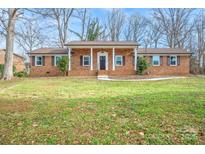 Brick ranch house with a covered porch and well-maintained lawn at 1254 Huckleberry Dr, Lincolnton, NC 28092